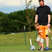 Father and Son playing FootGolf