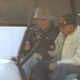 two elderly men in a golf cart